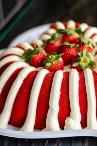 Delectable strawberry sponge cake topped with fresh cream and whole strawberries.